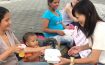 Yoriko gives a meal to a Venezuelan family in Medellin Colombia